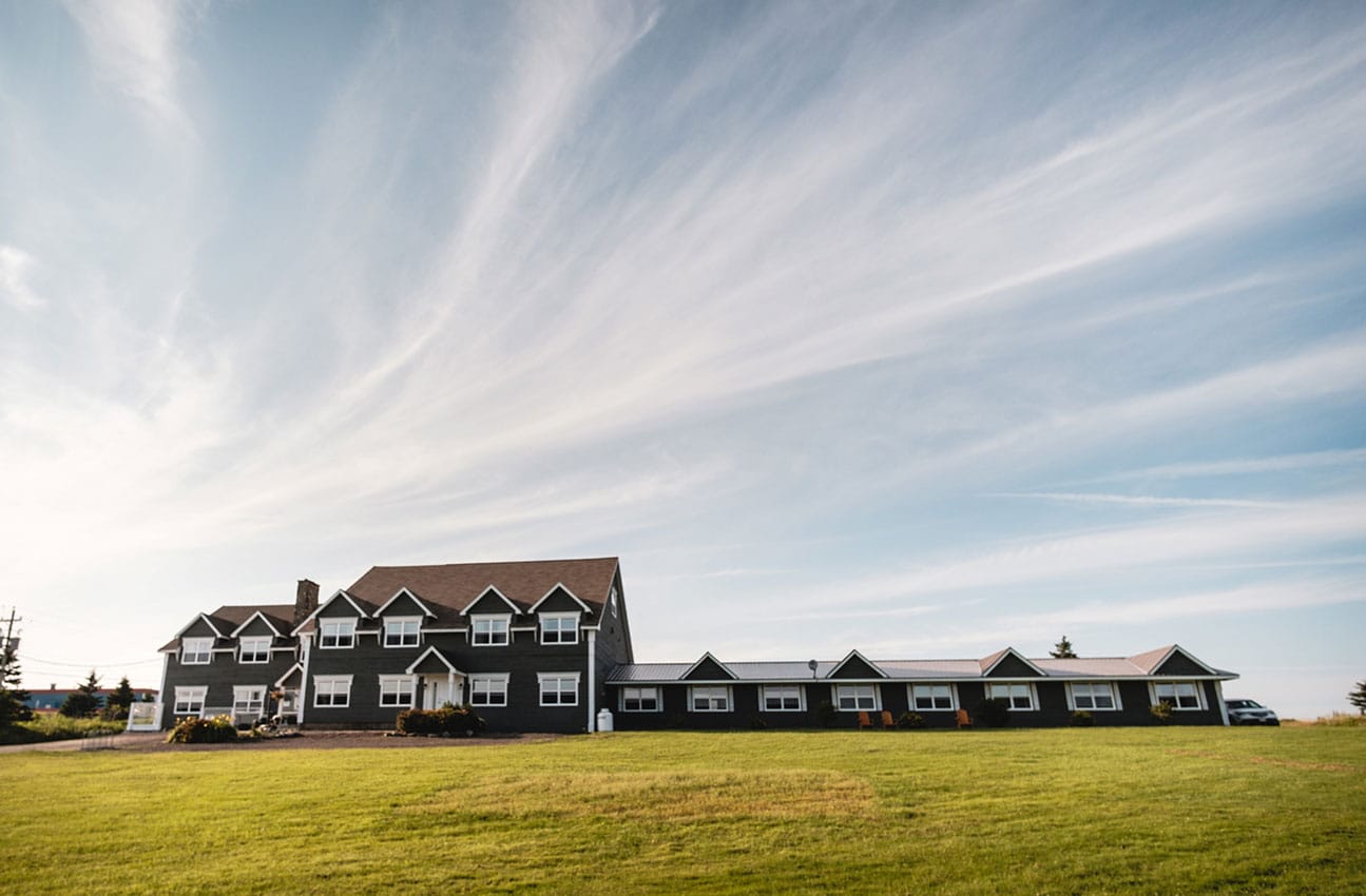 Exterior of a very large inn under a blue sky