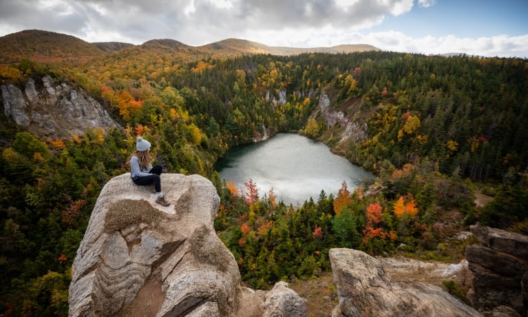 hiker stops to admire the fall foliage at the Gypsum Mine Quarry trail