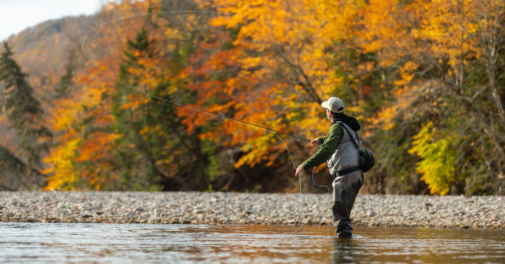 An angler casts a line in the Middle River of Cape Breton Island in the autumn.